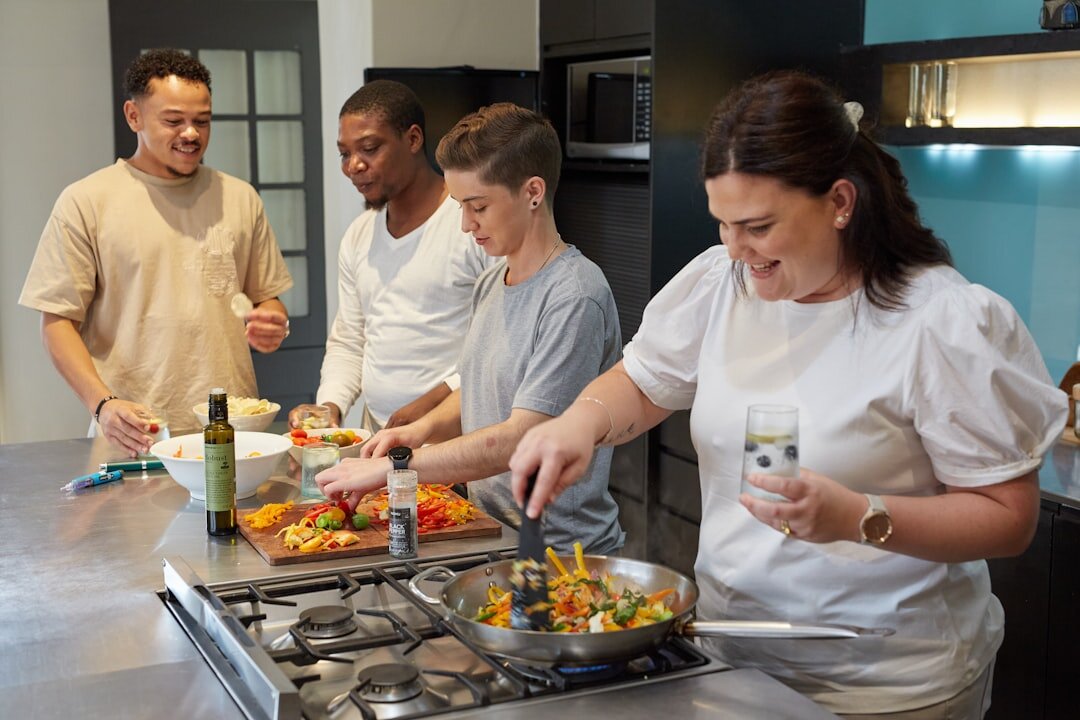 Coworkers cooking together during a team building culinary workshop
