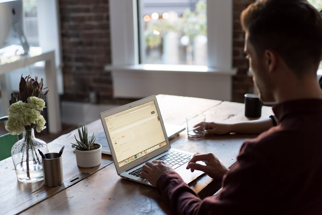 Event organizer typing on a laptop while planning a team building program