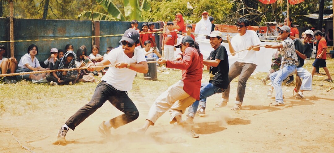 Coworkers competing in a friendly tug of war tournament